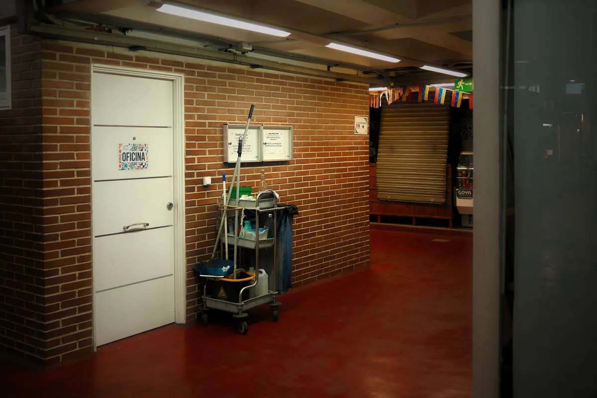 Cleaning cart in a hallway outside an office door