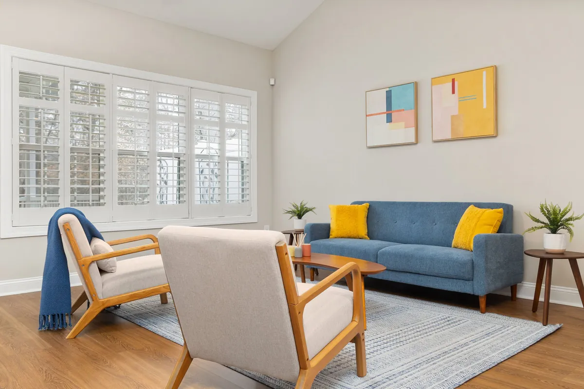 Bright living room with a blue sofa and yellow pillows
